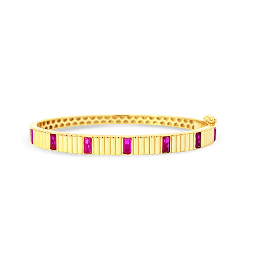 Sterling silver bezel set ruby bangle in yellow gold