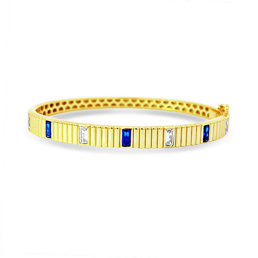 Sterling silver bezel set emerald and sapphire bangle in yellow gold