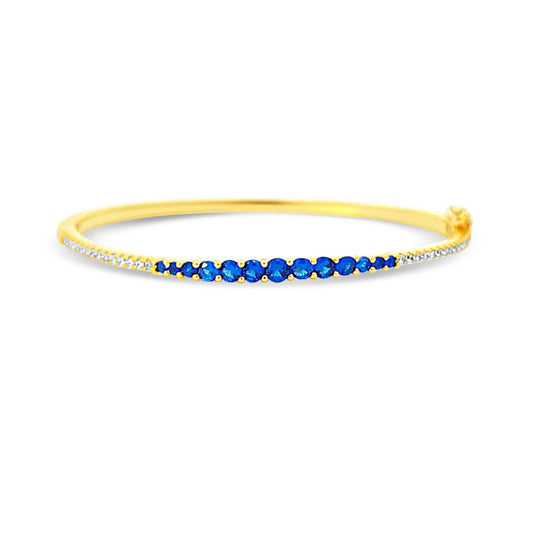 Sterling silver graduated tennis bangle with sapphire center