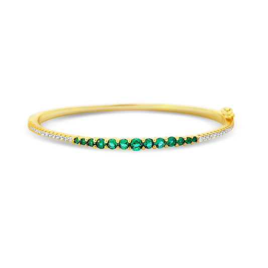 Sterling silver graduated tennis bangle with emerald center